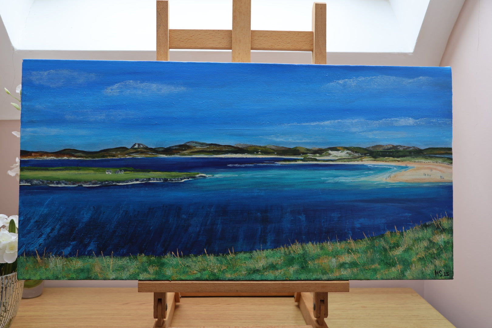 Painting of the coastal landscape of Narin Strand on an easel