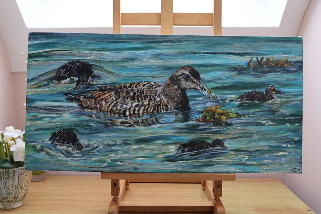 Painting of an eider duck swimming in water with her four ducklings on an easel.